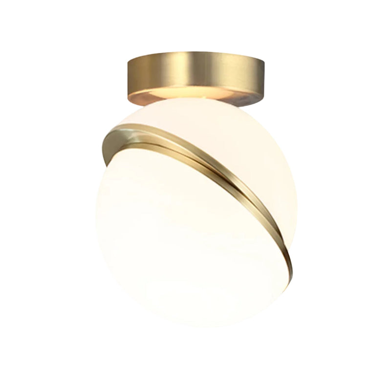 CRESCENT ceiling lamp with an opal shade and brass accents. — Lee Broom