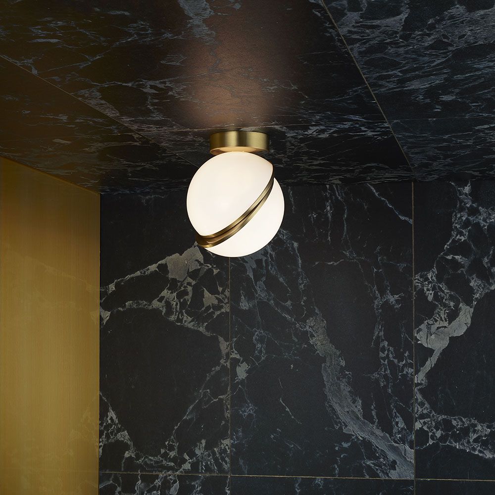 CRESCENT ceiling lamp with an opal shade and brass accents. — Lee Broom